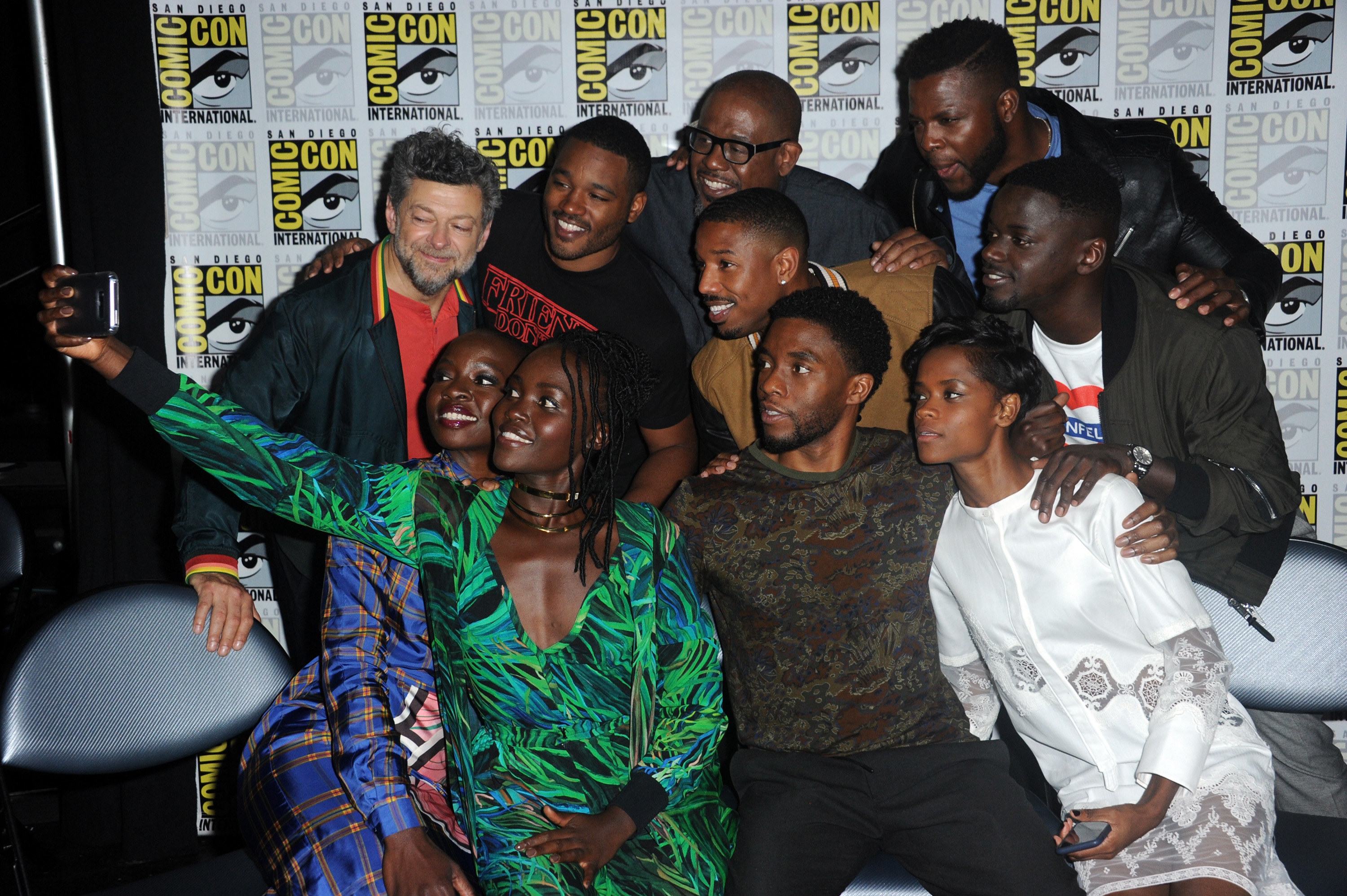 The cast huddles together for a selfie at an interview
