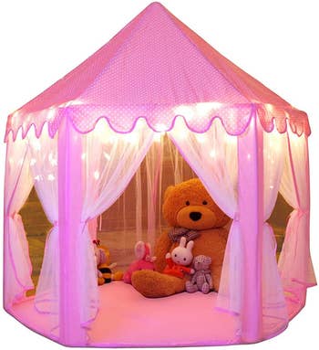 The pink tent with lights and stuffed animals inside