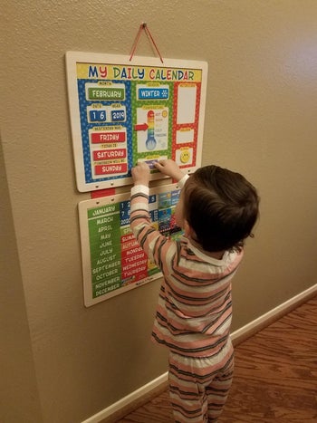 Reviewer's child using the magnetic calendar