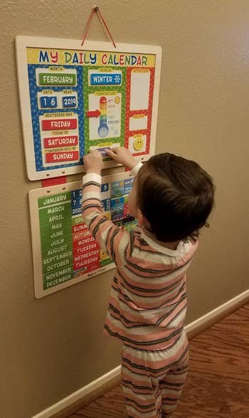 Reviewer's child using the magnetic calendar