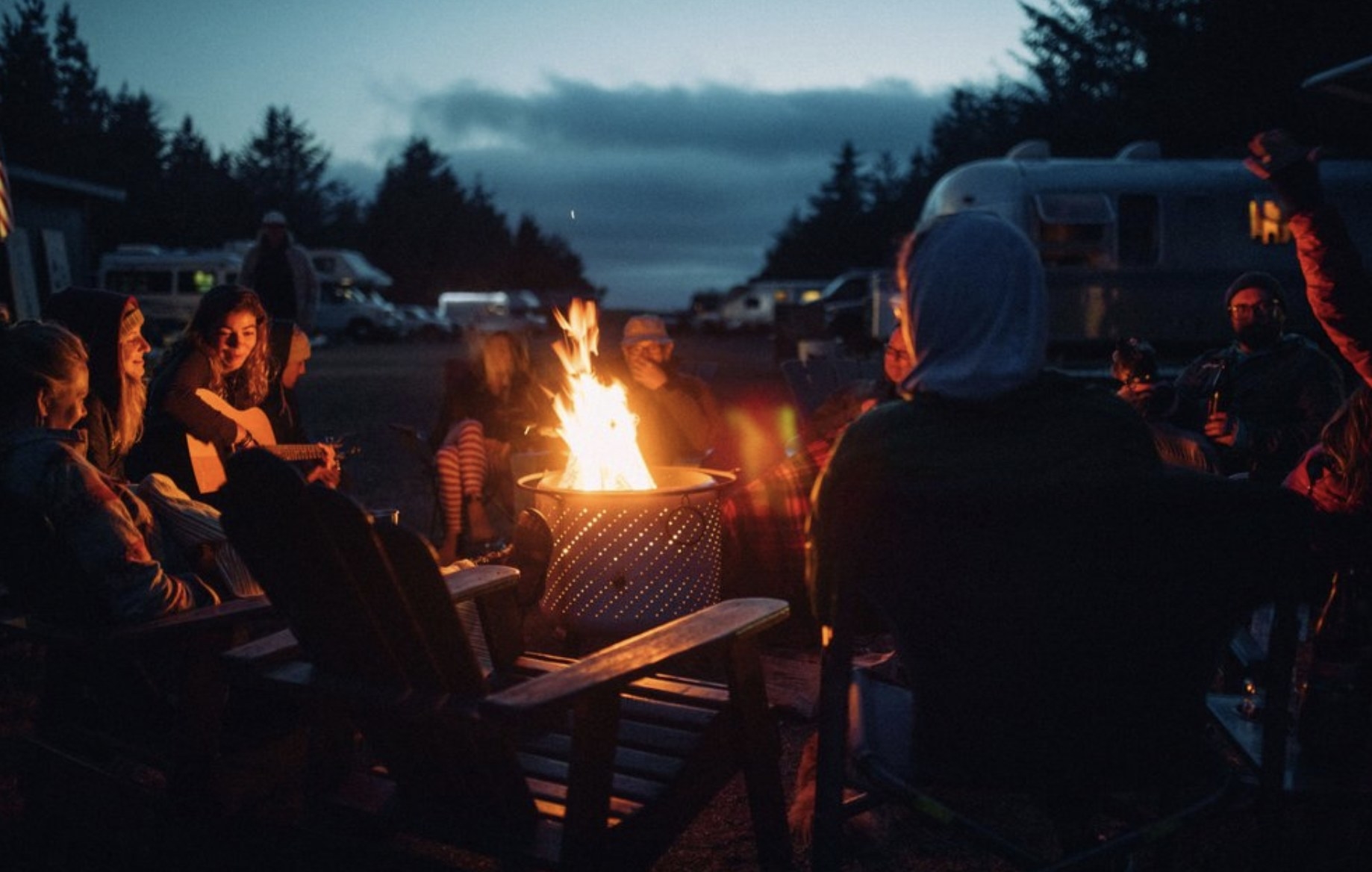 People gathering around a campfire