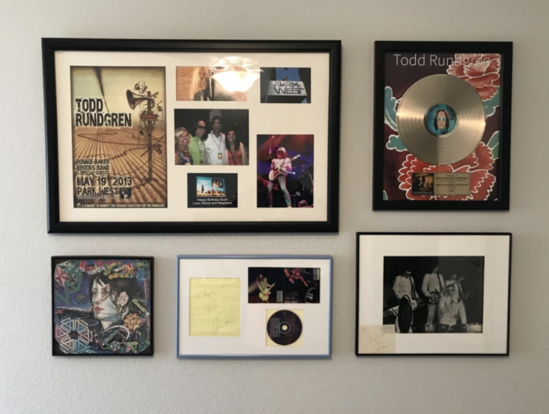 reviewer&#x27;s pic of gallery wall of various sized framed items using the hanger