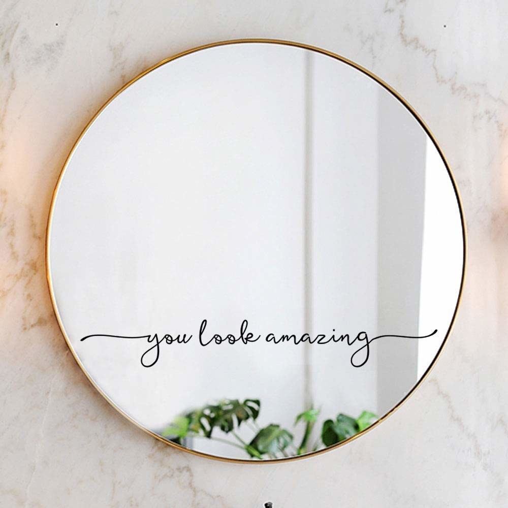 circular mirror with sticker that reads &quot;you look amazing&quot;