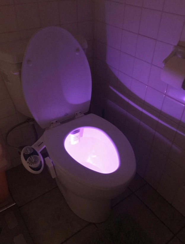 toilet lit up with pink light