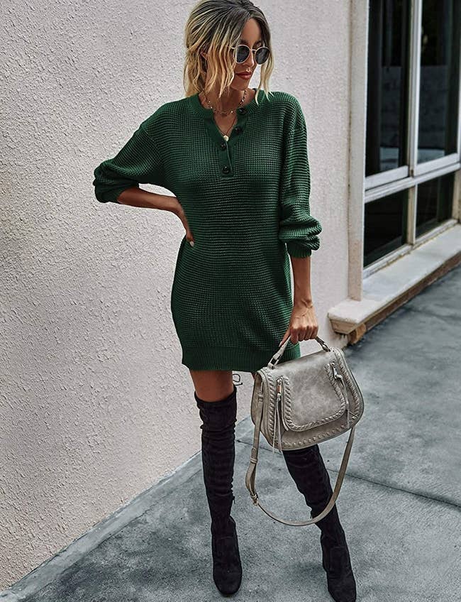 model wearing the green long-sleeve dress with black thigh-high boots