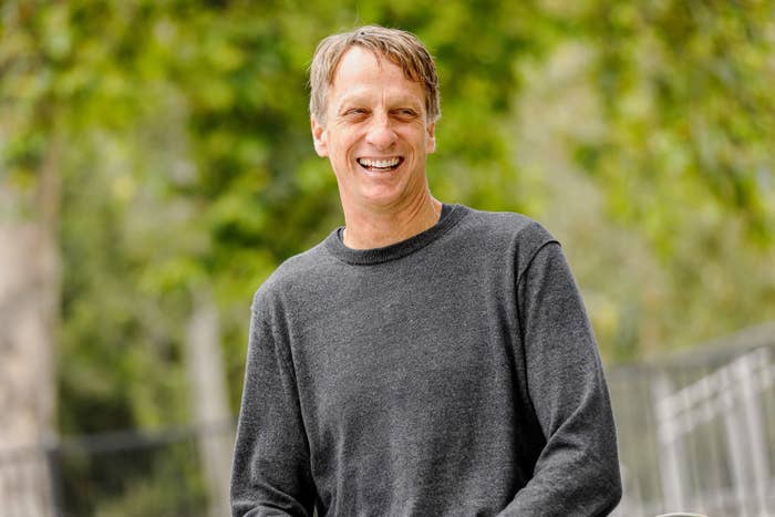 Tony Hawk smiling outside and wearing a long-sleeved shirt