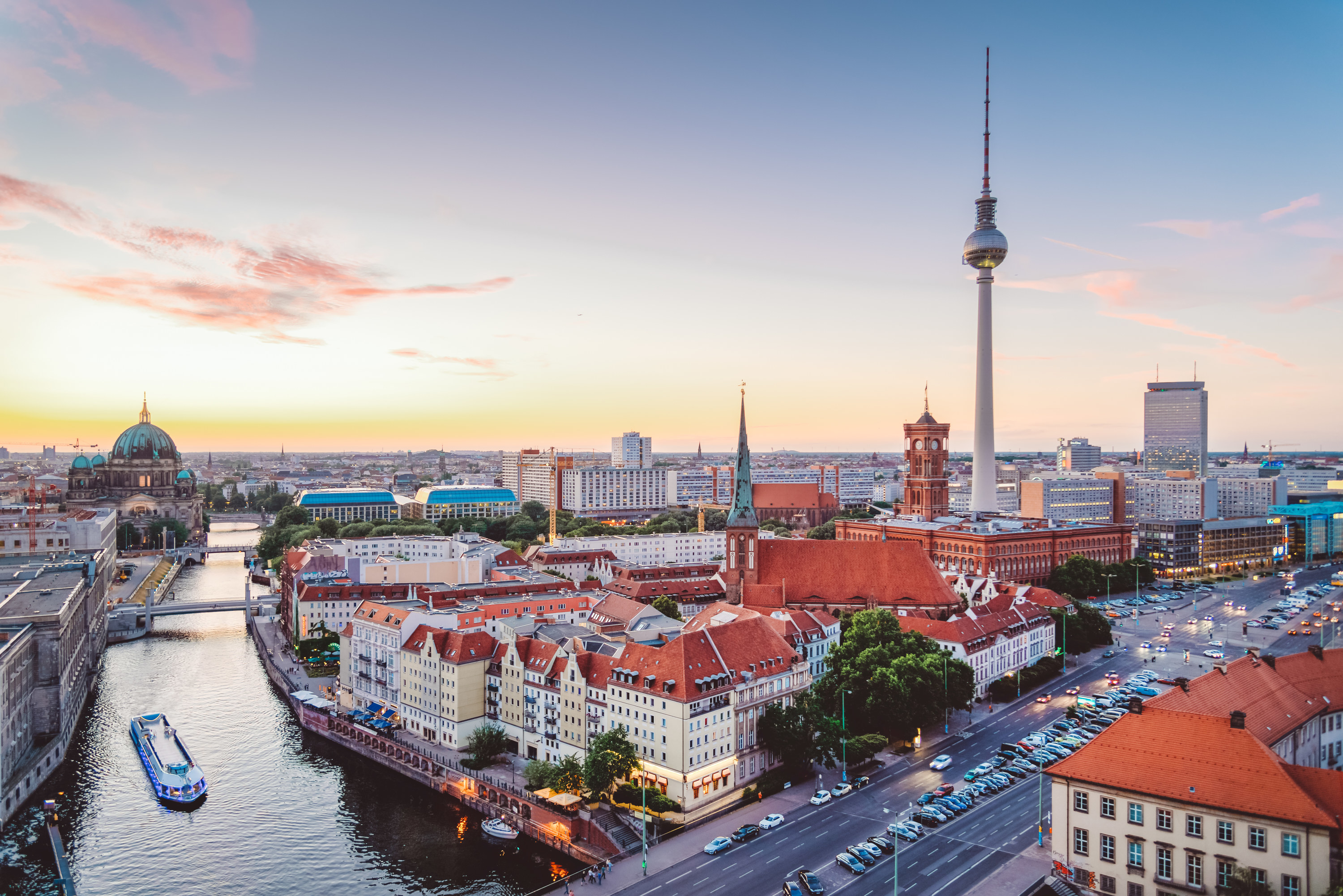 View of Berlin&#x27;s TV tower, Berlin&#x27;s main river, and other city landmarks with a sunset in the background