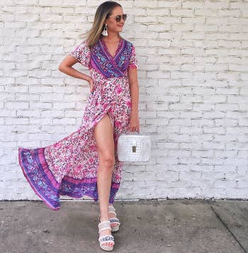 reviewer wearing a pink and purple floral version with heeled sandals