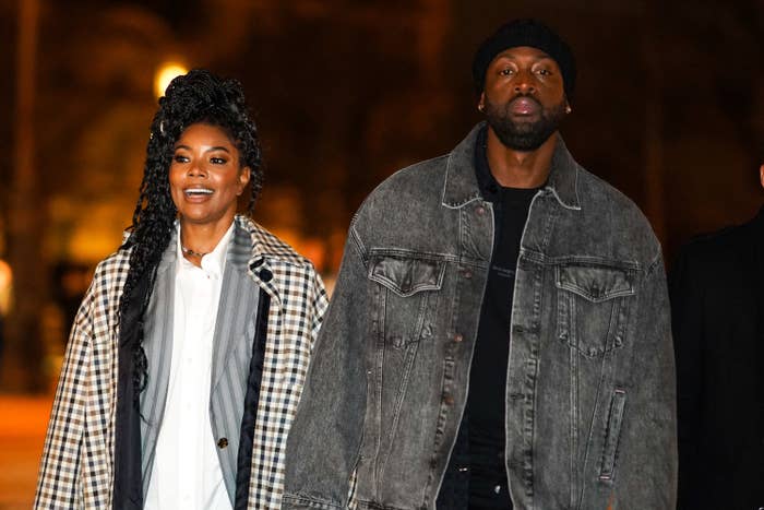 Gabrielle and Dwyane, both casually dressed, walking outside at night