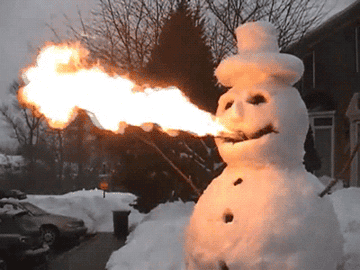 A snowman blowing fire