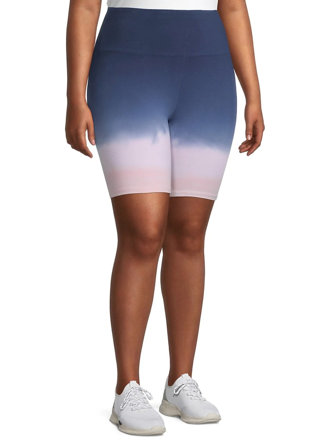 model wearing the biker shorts that are blue up top and fade into light pink at the bottom