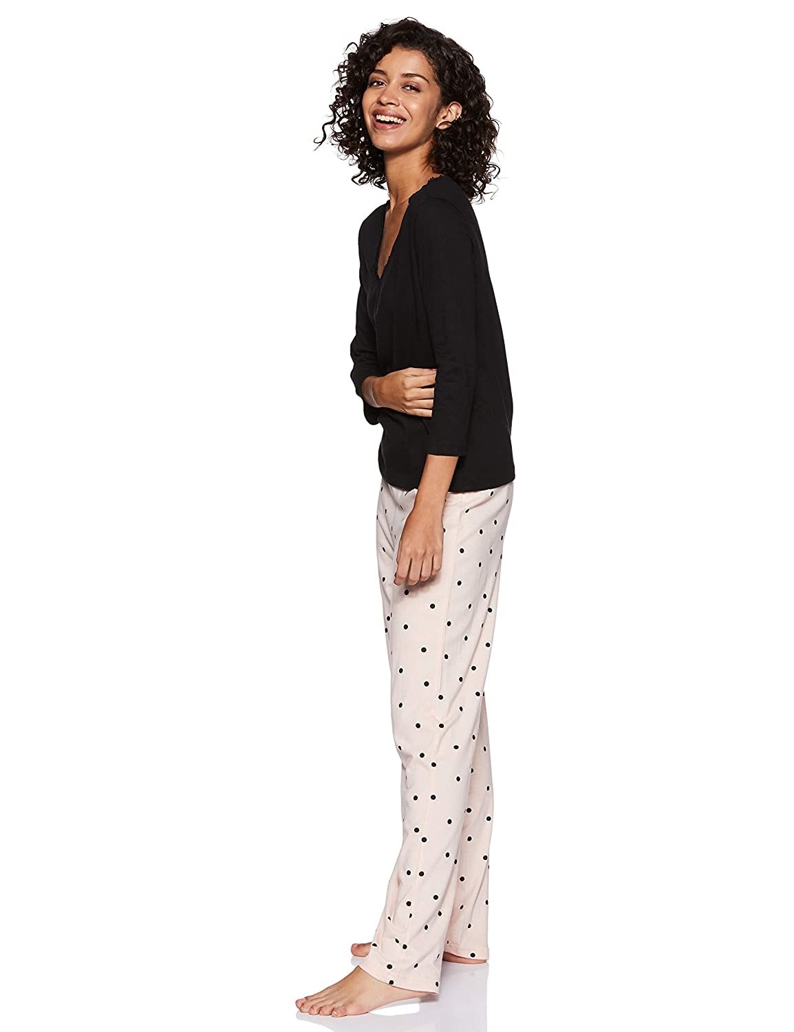The set consists of a long-sleeved top and polka dotted pyjamas