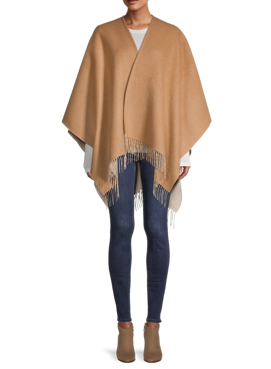 model wearing the cape in tan with blue jeans and brown boots