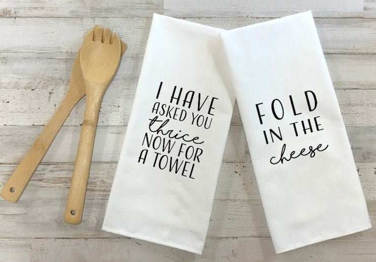 a pair of tea towels that say &quot;I have asked you thrice now for a towel&quot; and &quot;fold in the cheese&quot;