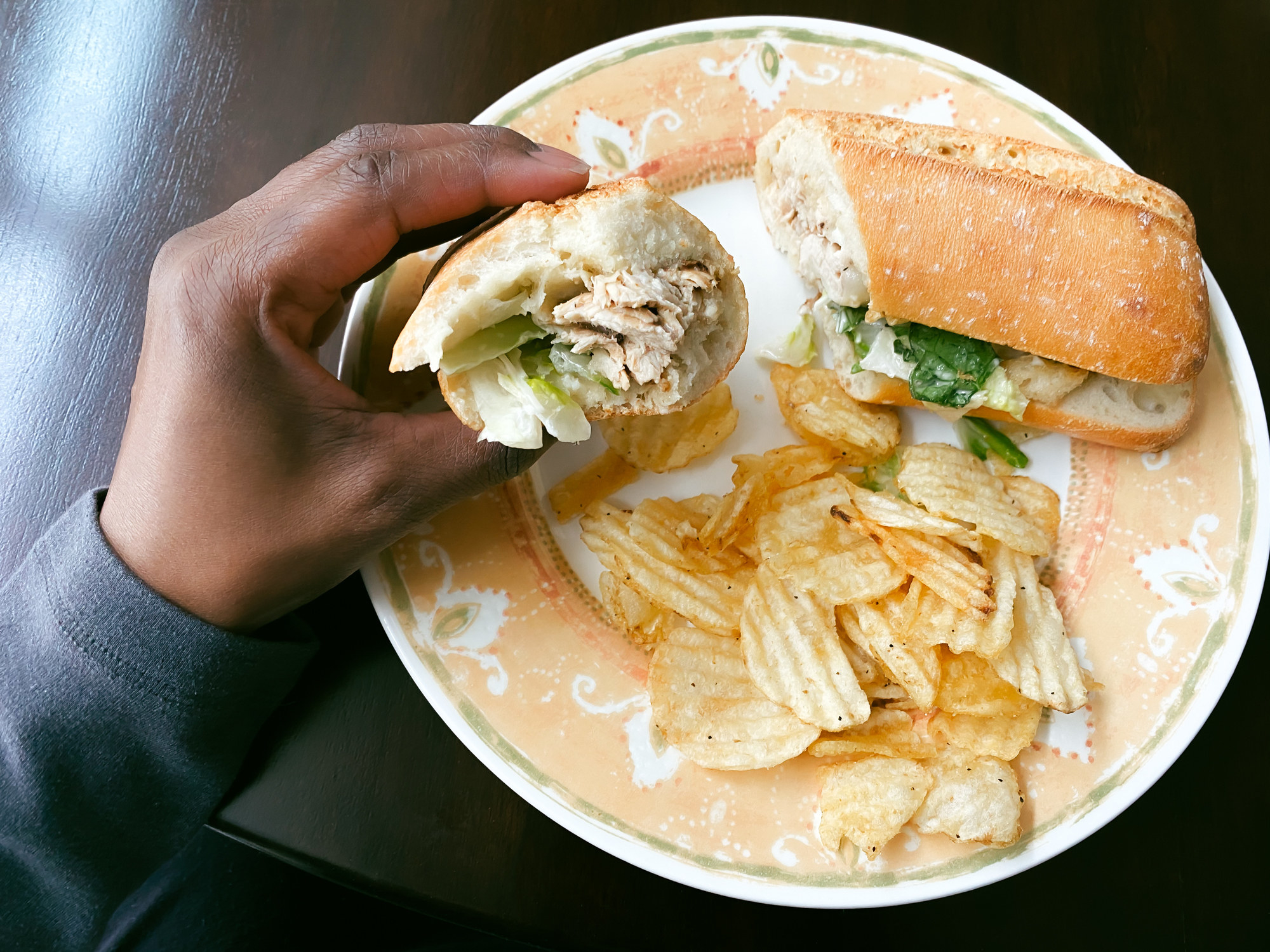 Woman Eats Chicken Sandwich With Side of Chips