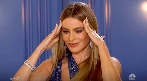 Sofía Vergara clutching her forehead in distress