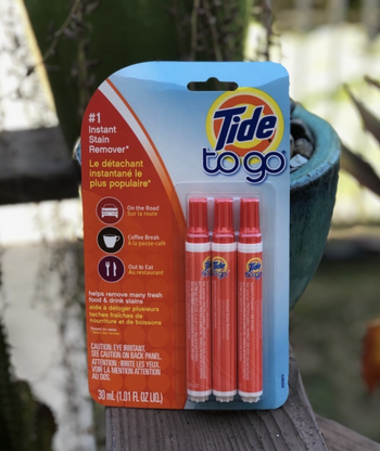 reviewer image of three orange pens in the packaging 