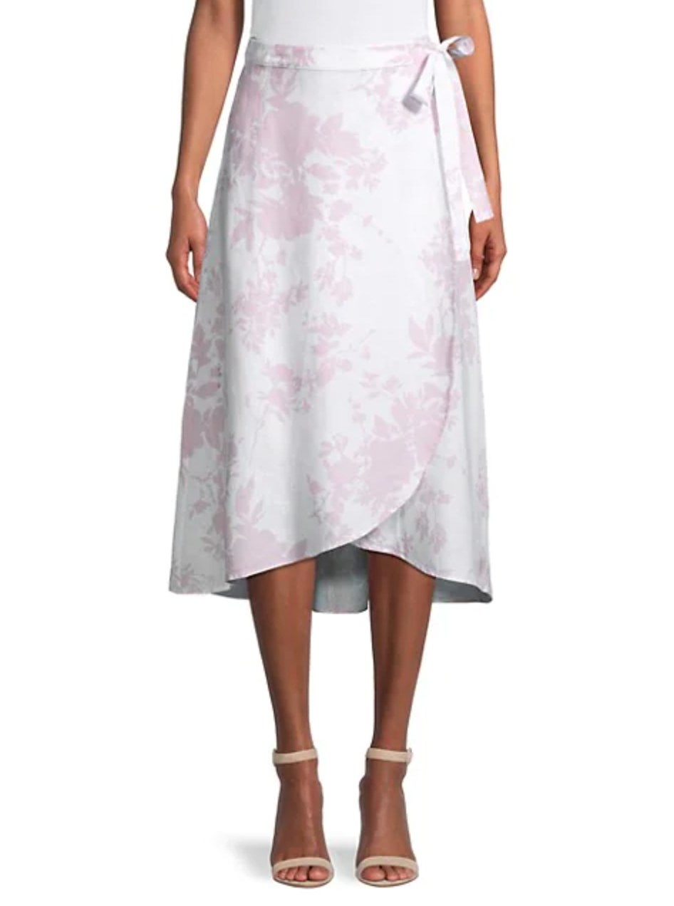 model wearing the skirt with white and pink pattern and tan shoes