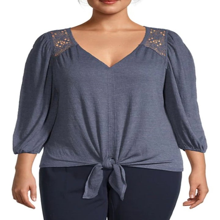 model wearing the top in blue with a knot tied in the center