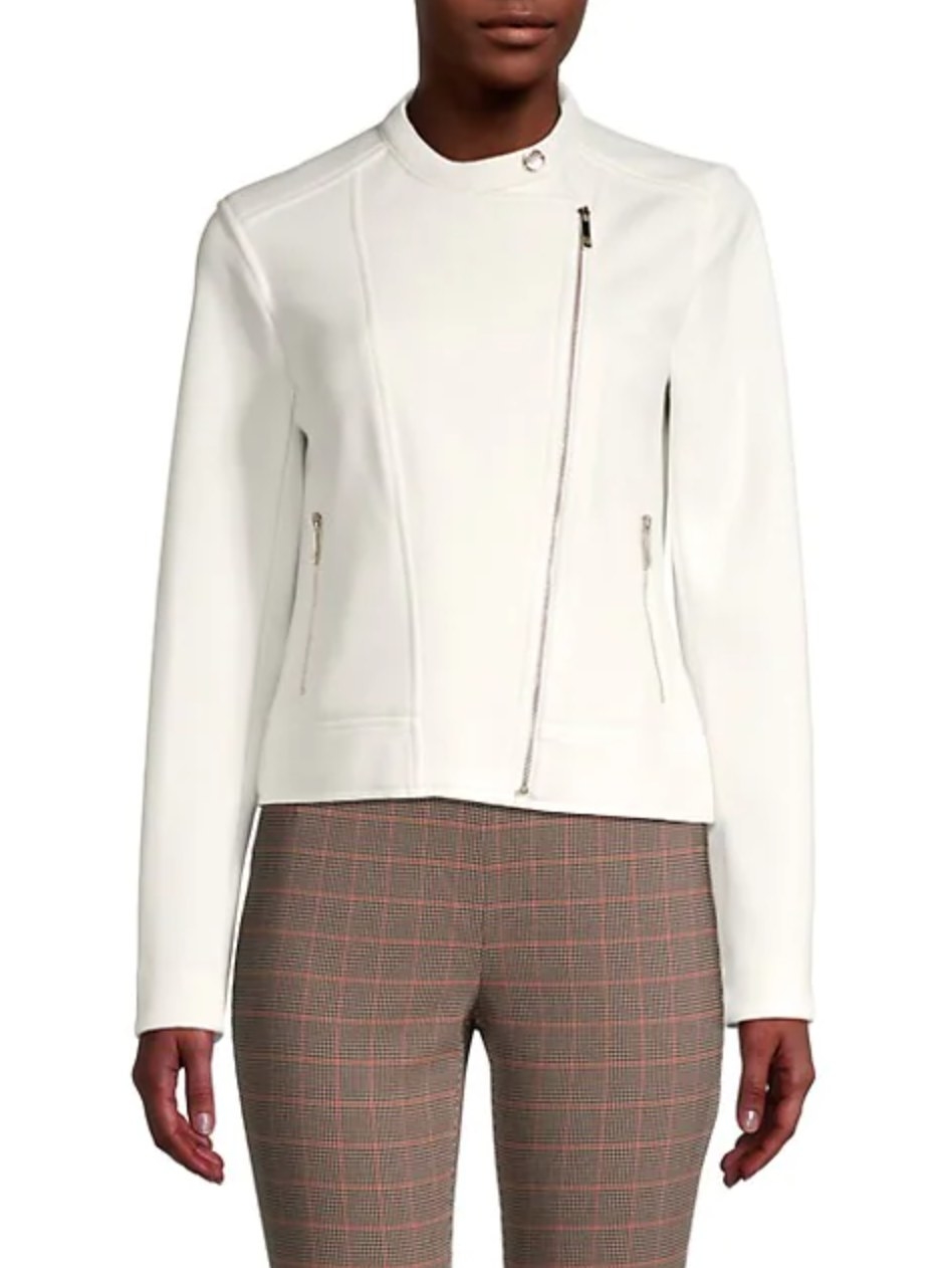 model wearing the white jacket with brown and red checkered pants