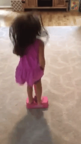 Reviewer's child jumping on the pink pogo stick