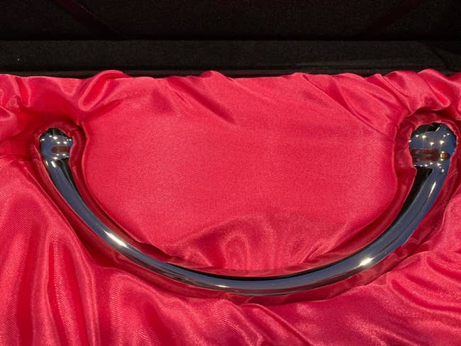 Curved stainless steel wand dildo in red box