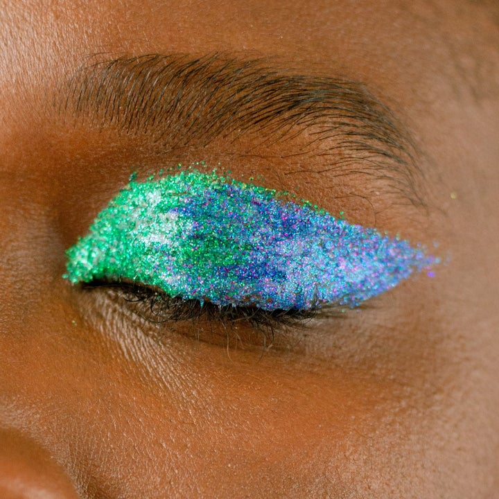 model wearing a bold green and blue eye look after using the eyeliners