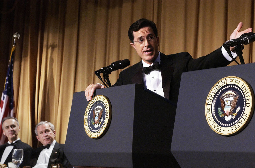 Stephen Colbert performs while Bush watches