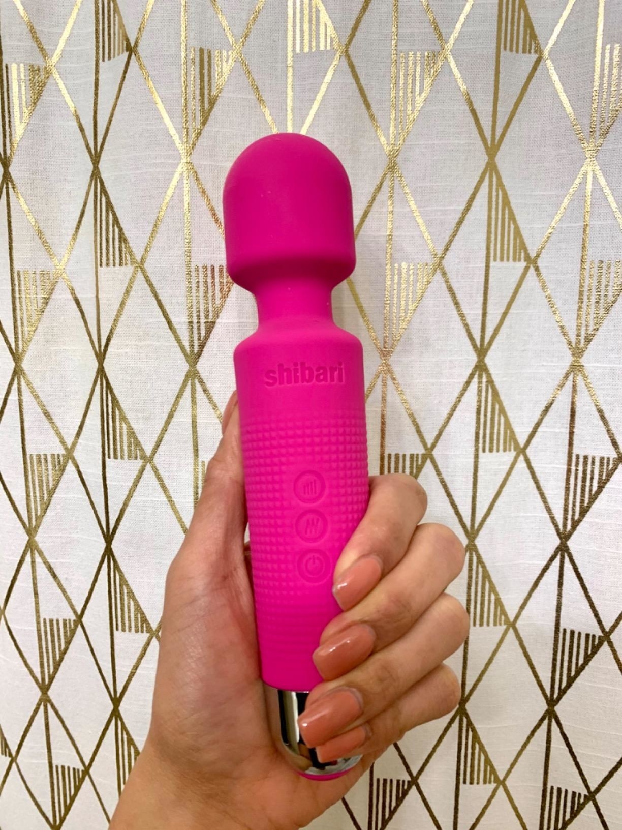 Model holding pink vibrating wand