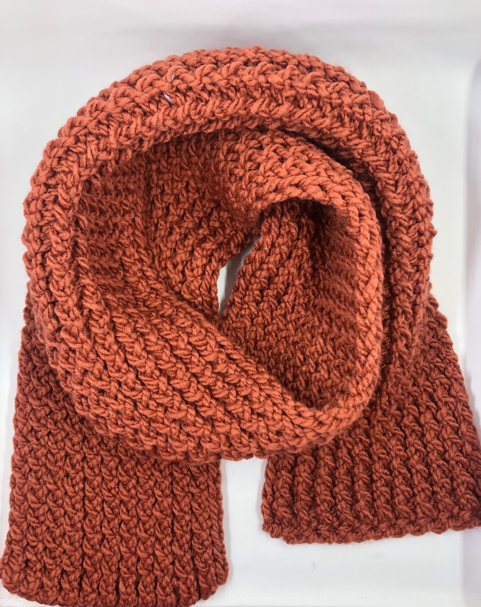 A burnt orange-colored scarf