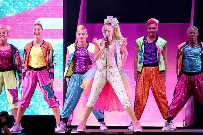 JoJo performing on stage with several backup dancers