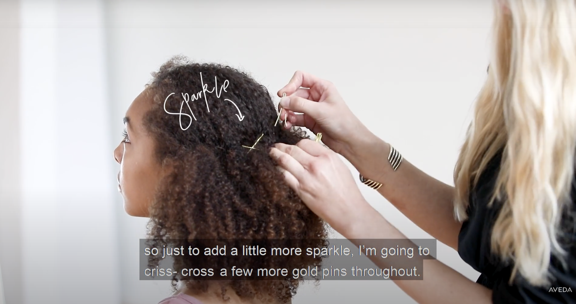 A hairdresser pinning bobbypins in this style on a model
