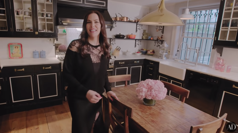 Liv standing in her kitchen