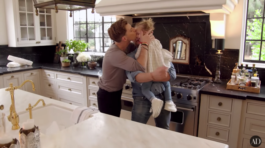 Jeremiah, Nate, and Poppy sharing a precious moment in their kitchen