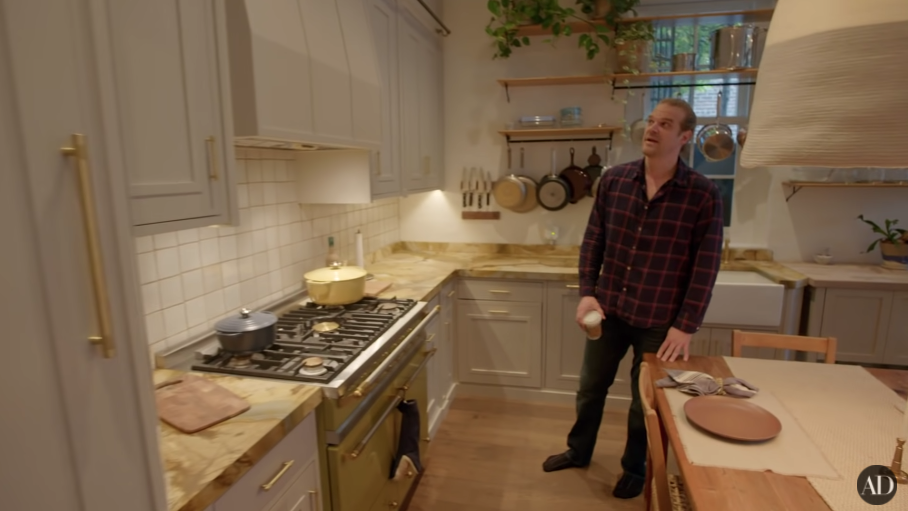 David Harbour standing in his kitchen