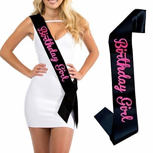 A black sash with the words &#x27;Birthday Girl&#x27; written on it in pink