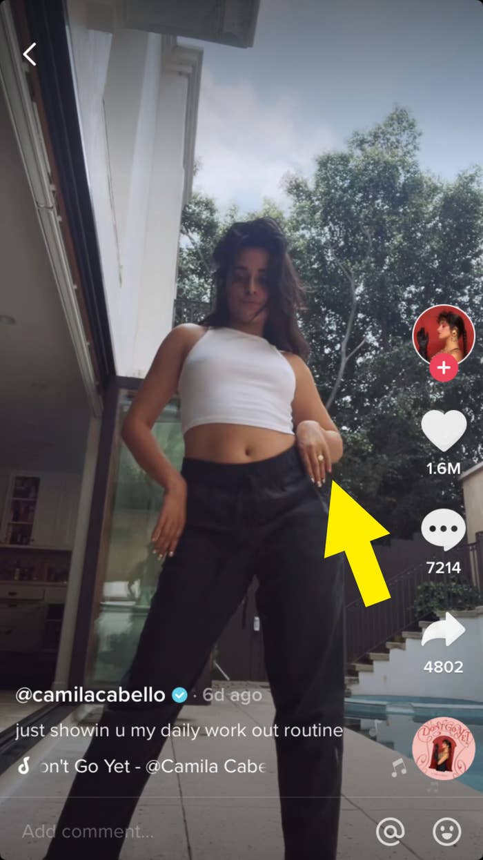 Camila standing and an arrow pointing to her left hand, where she&#x27;s wearing a ring on her ring finger, with the caption &quot;just showin u my daily work out routine&quot;