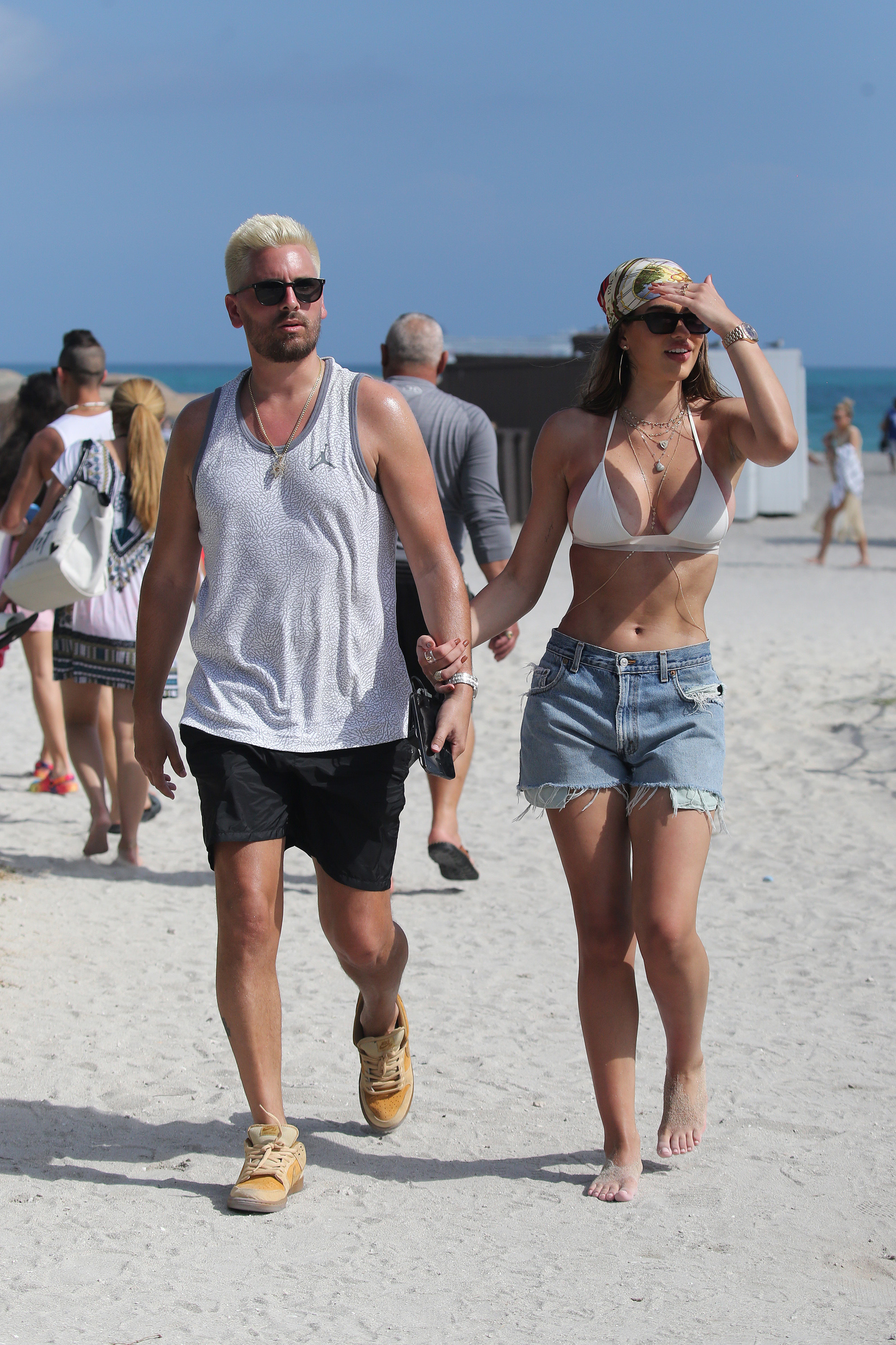 Scott and Amelia walking hand in hand on the beach