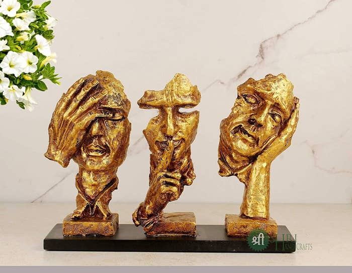 Set of 3 modern face sculptures with different hand actions like one hand on eyes, a single finger on the lips