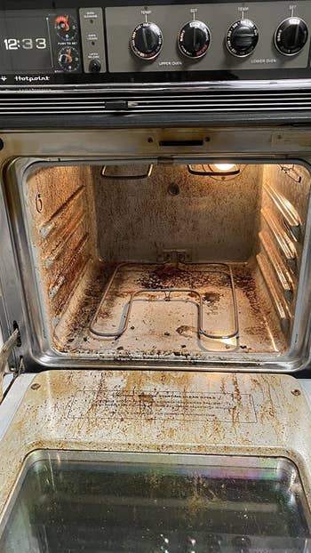 reviewer before image of the inside of an incredibly dirty and stained oven