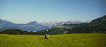 Julie andrews twirling in a field in the sound of music