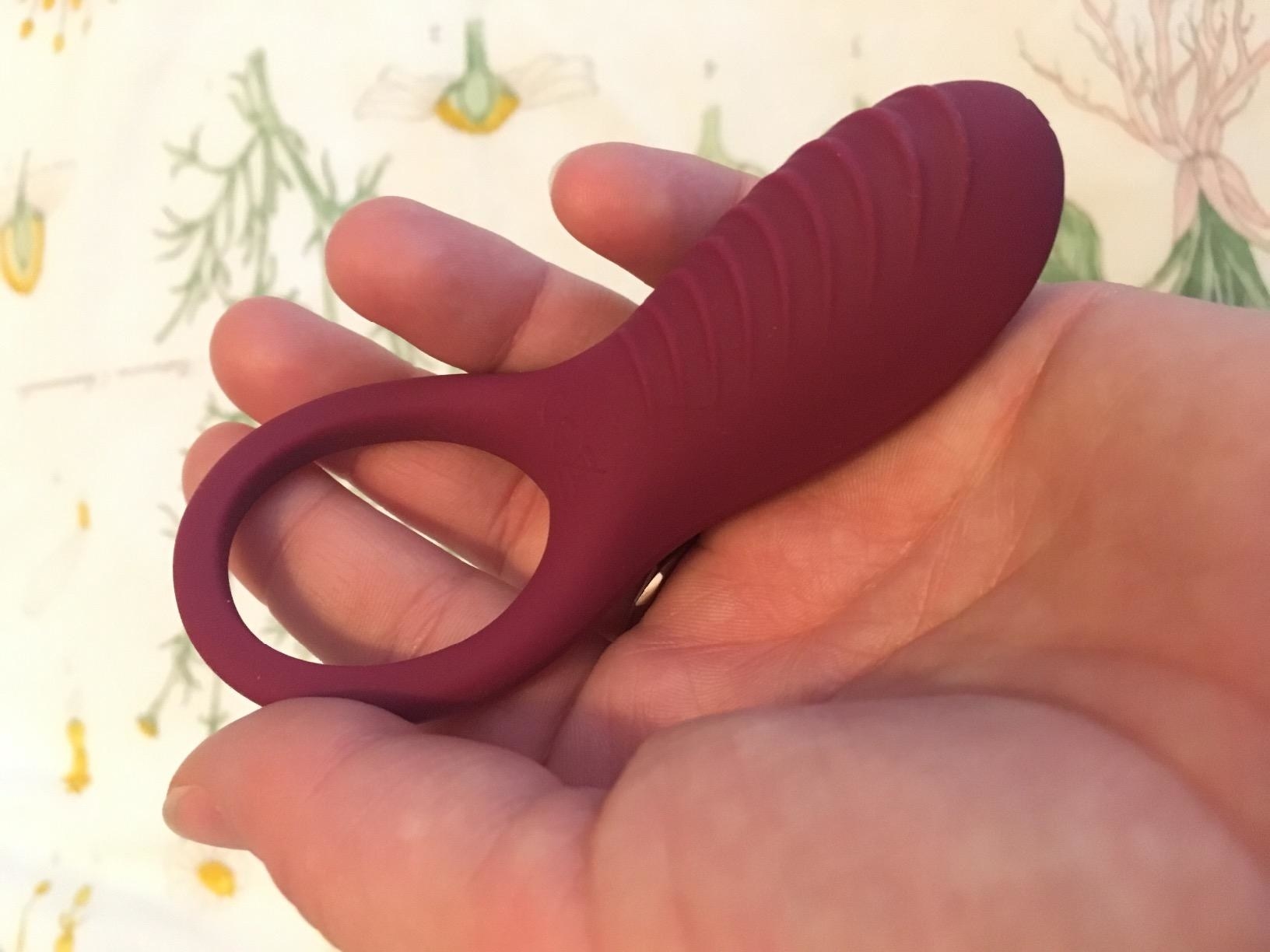 Model holding pink cock ring to display ribbed base