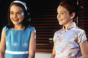 Annie wears a brightly colored dress and Hallie wears a high-neck silk dress