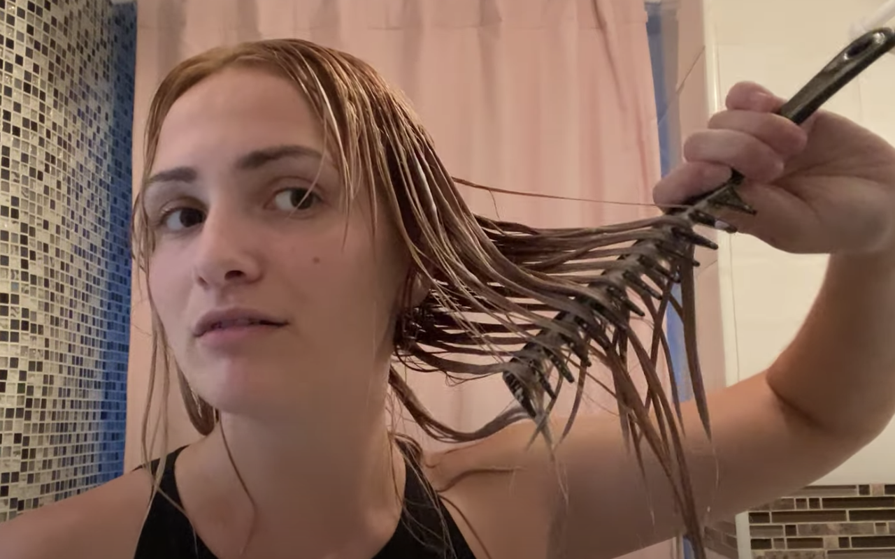 Me brushing through my hair, showing how saturated in product it is