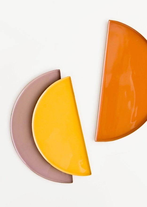 three catchall dishes in yellow, orange, and purple