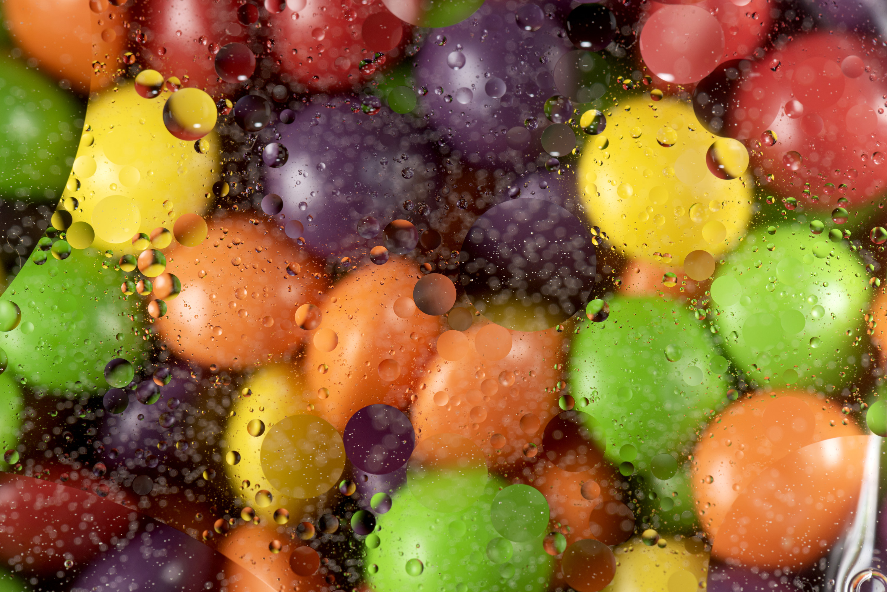 Colorful round candies behind a foggy layer of glass with water drops