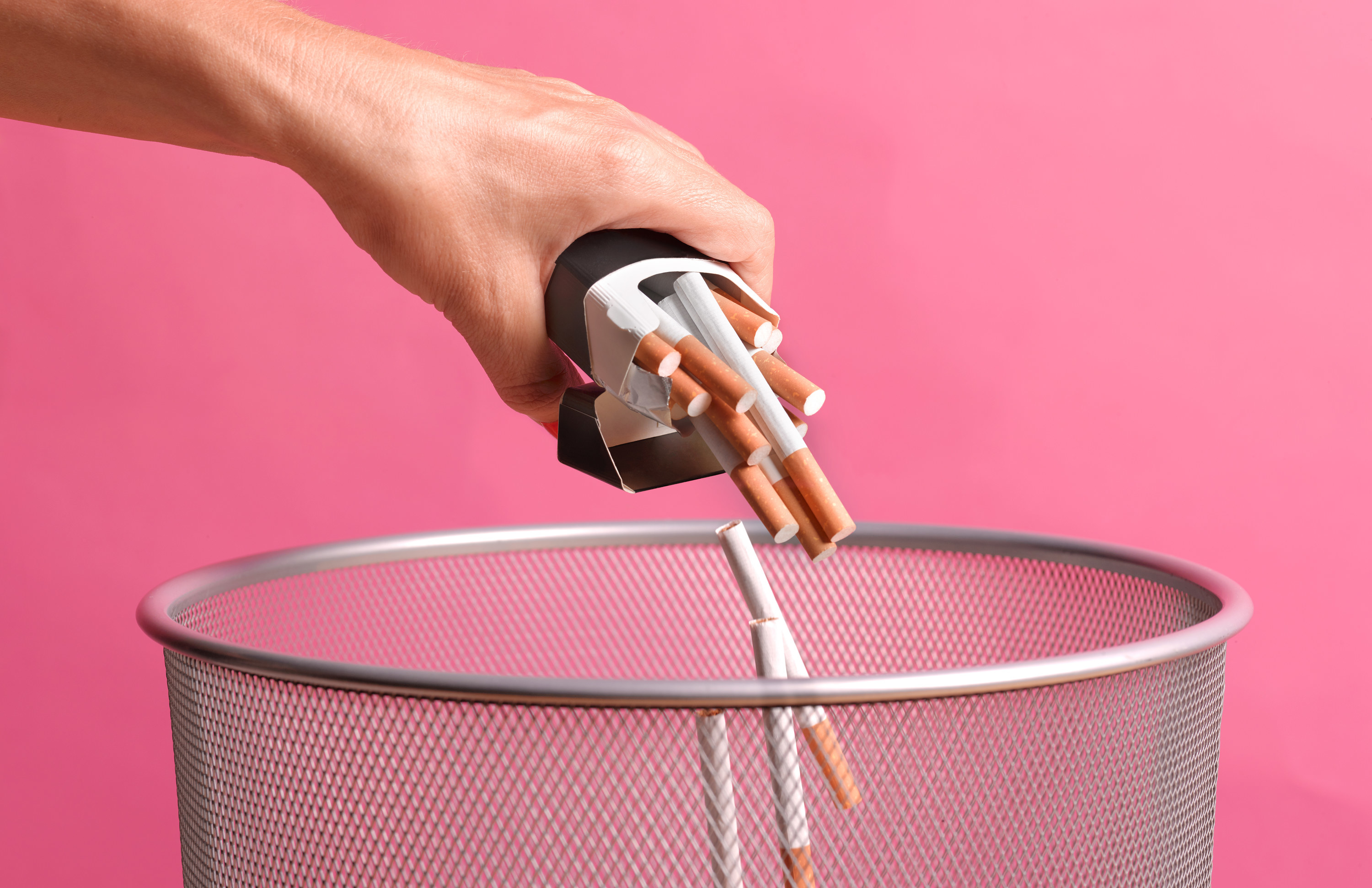 An image of cigarettes being thrown into the trash