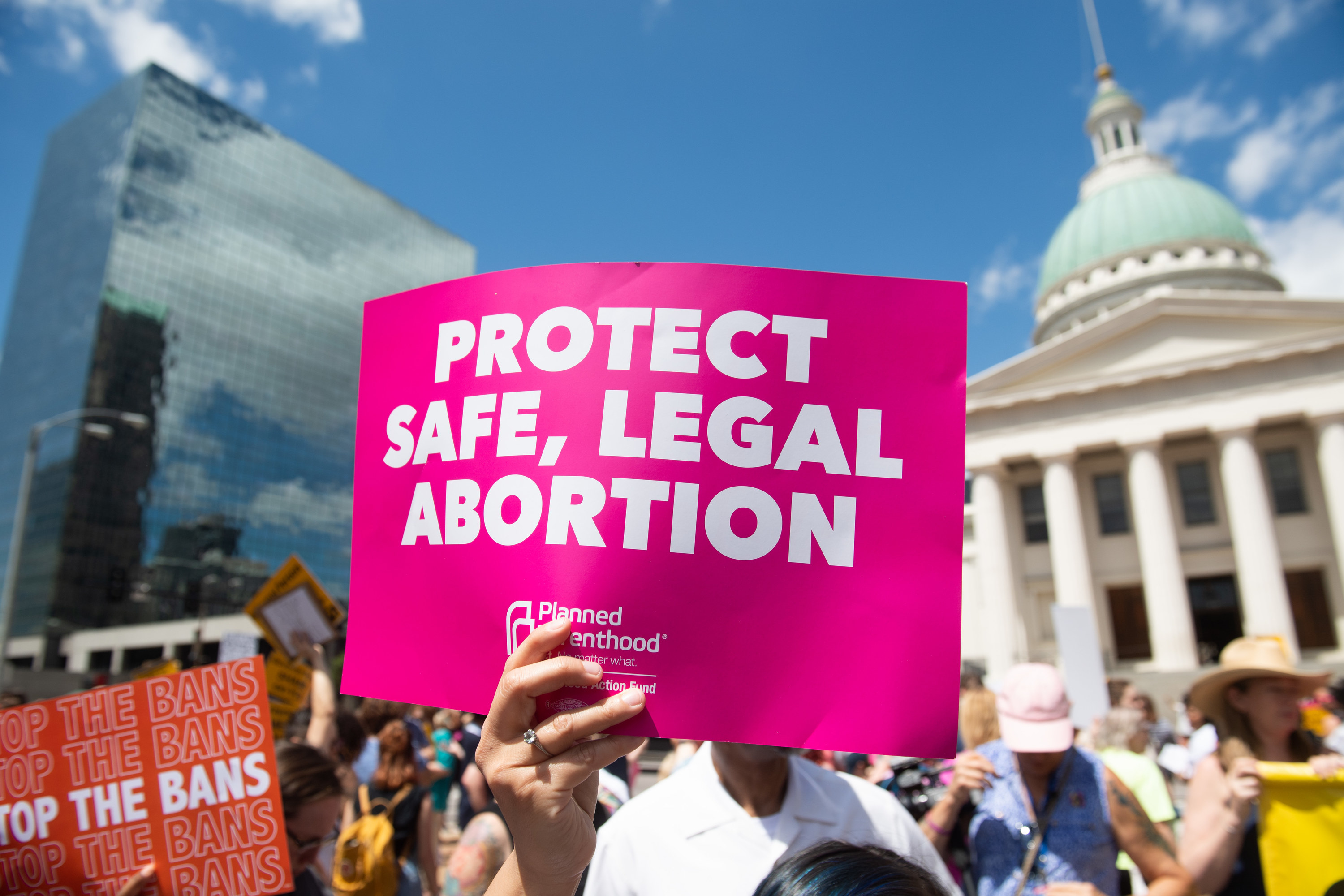 An image of a sign at a protest saying, &quot;Protect safe, legal abortion&quot;
