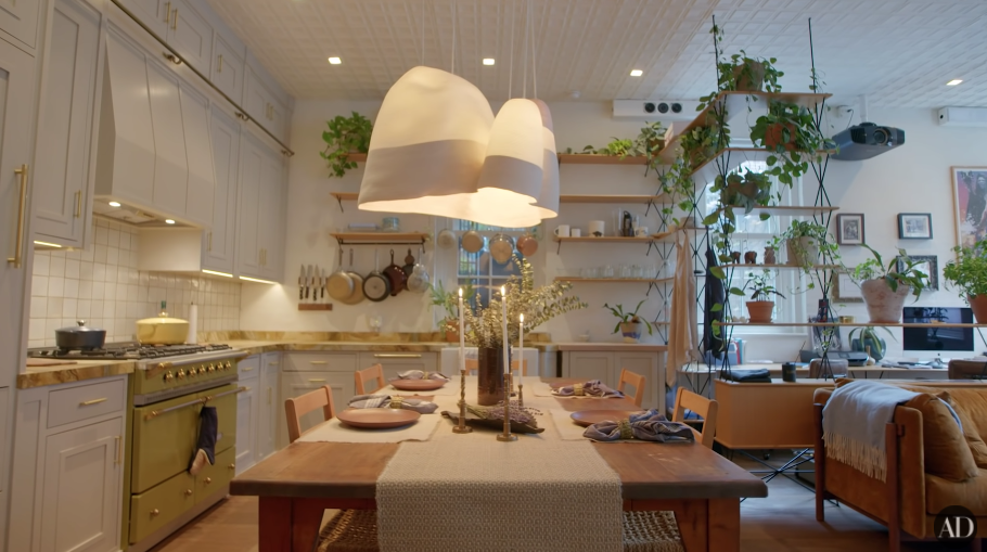 Another view of David&#x27;s large kitchen, with many plants and a large island