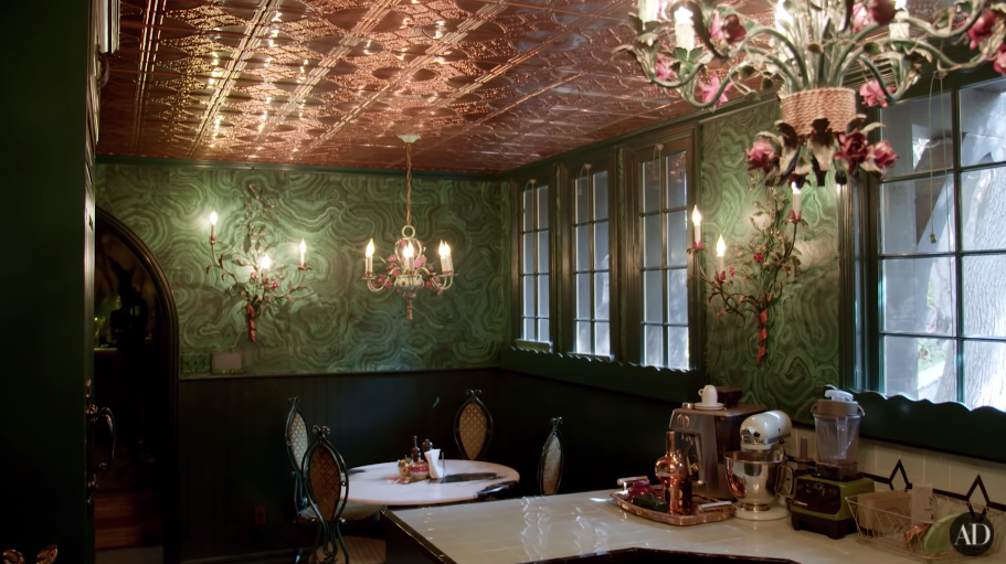 Another photo of Dita&#x27;s green-themed kitchen with chandeliers